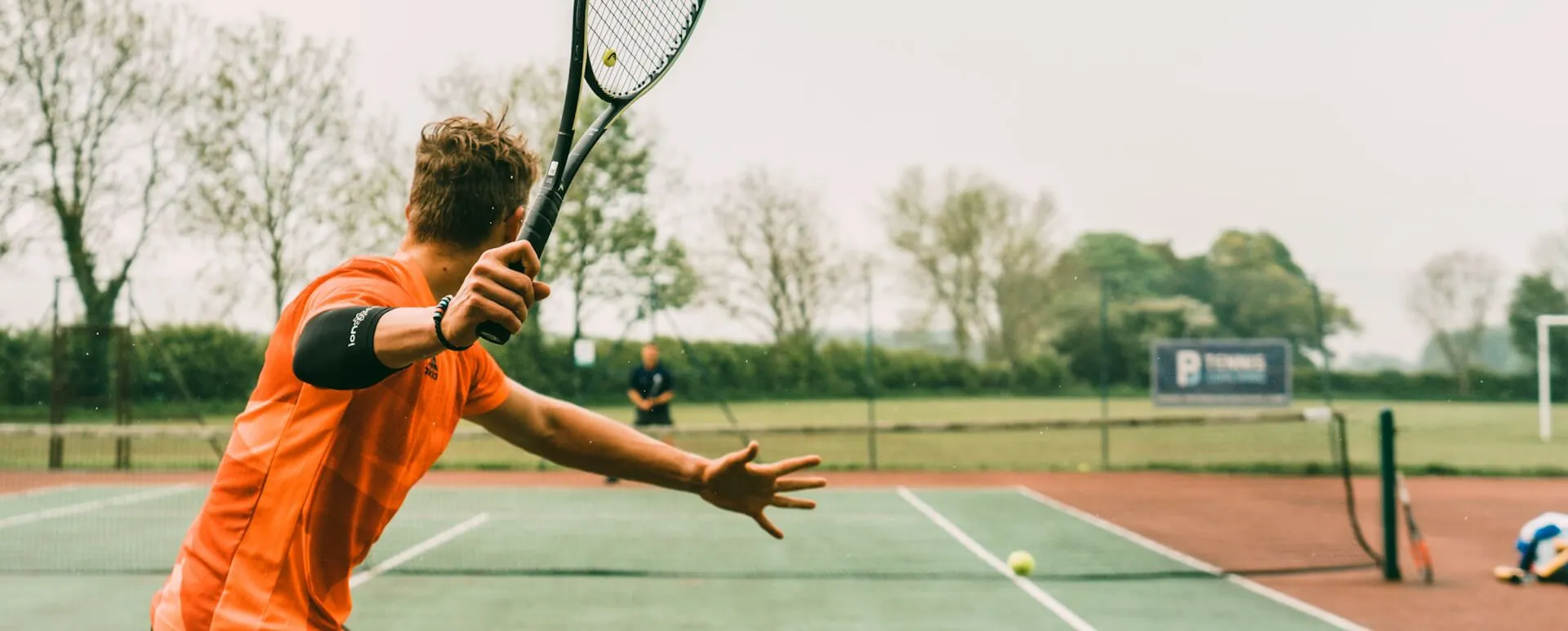 Tennis player mid-serve